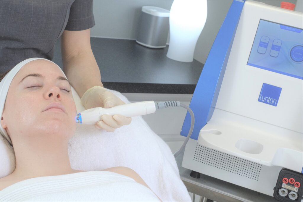 Aesthetician performing skin tightening RF on a client