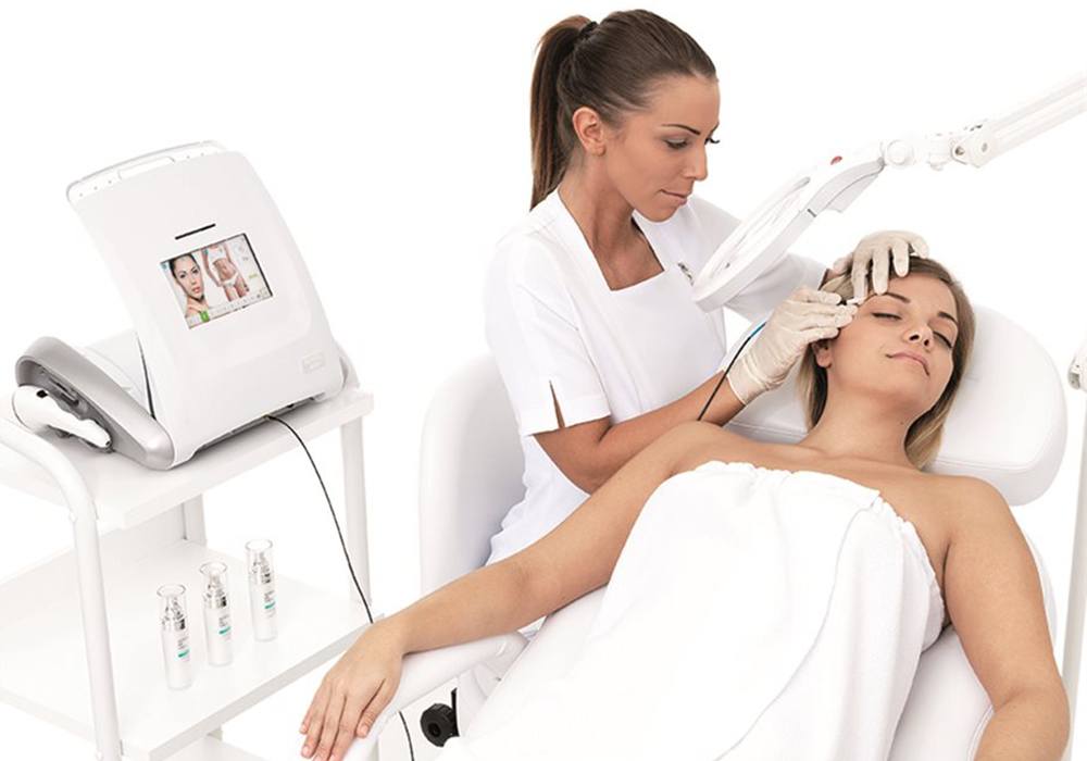 electrologist removing hair from face using electrolysis