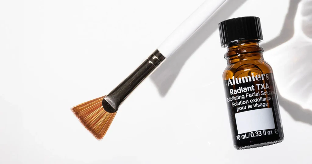 Bottle of chemical skin peel and a brush