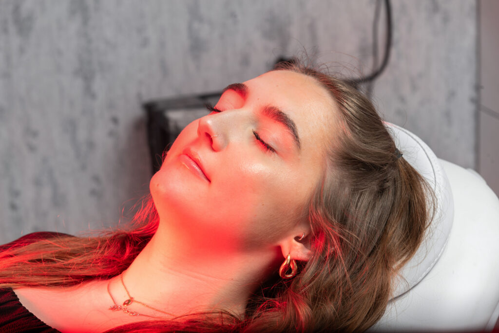 Woman having dermalux led tri-wave md treatment