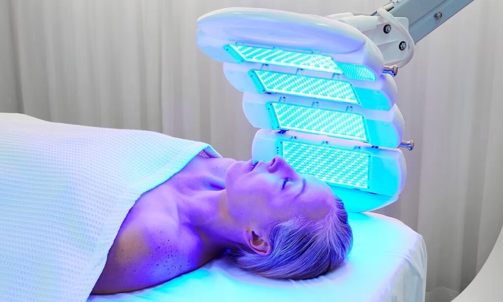 Woman under LED light tri-wave md blue light